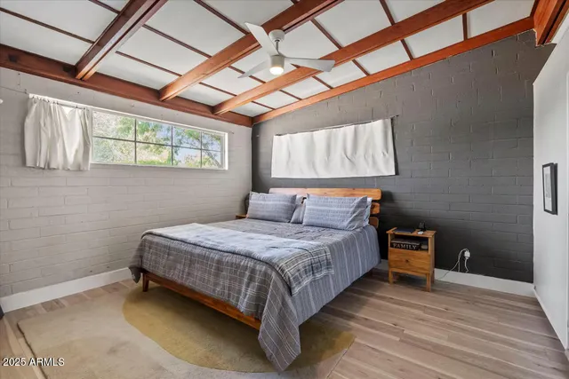 a bedroom with a bed and wooden cabinets