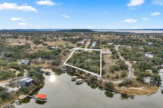 an aerial view of a houses with city view