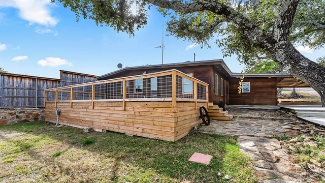 a view of a balcony with wooden floor space