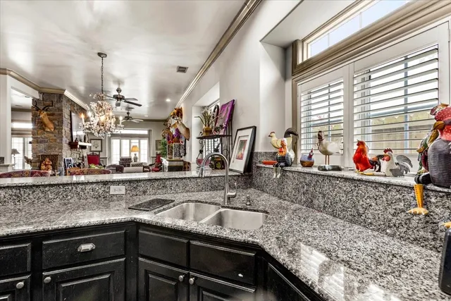 a living room with furniture a chandelier and a rug