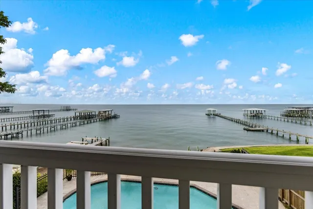 a bedroom with a bed and a flat tv screen on a dresser