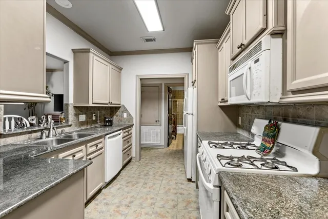 a bathroom with a granite countertop sink a mirror and a shower