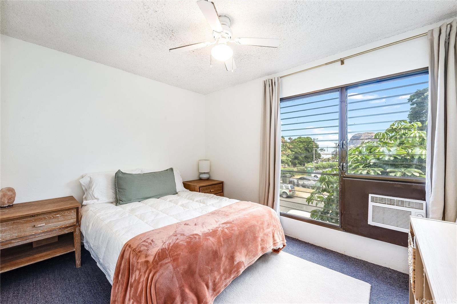 87-119 Helelua Street, Unit F202 Waianae, HI 96792 - Photo 13 of 25 a bedroom with a bed and a large window