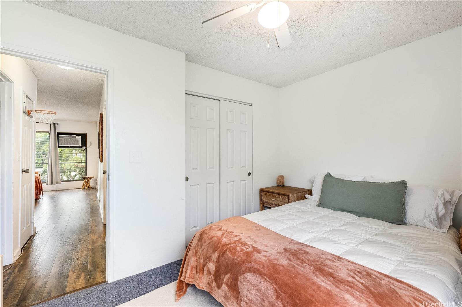 87-119 Helelua Street, Unit F202 Waianae, HI 96792 - Photo 14 of 25 a bedroom with a bed and a table