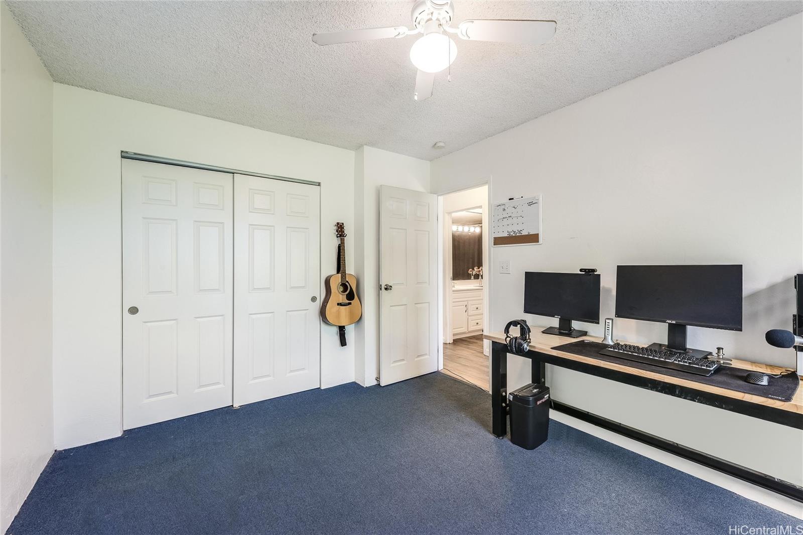87-119 Helelua Street, Unit F202 Waianae, HI 96792 - Photo 16 of 25 a view of a workspace with furniture and a ceiling fan