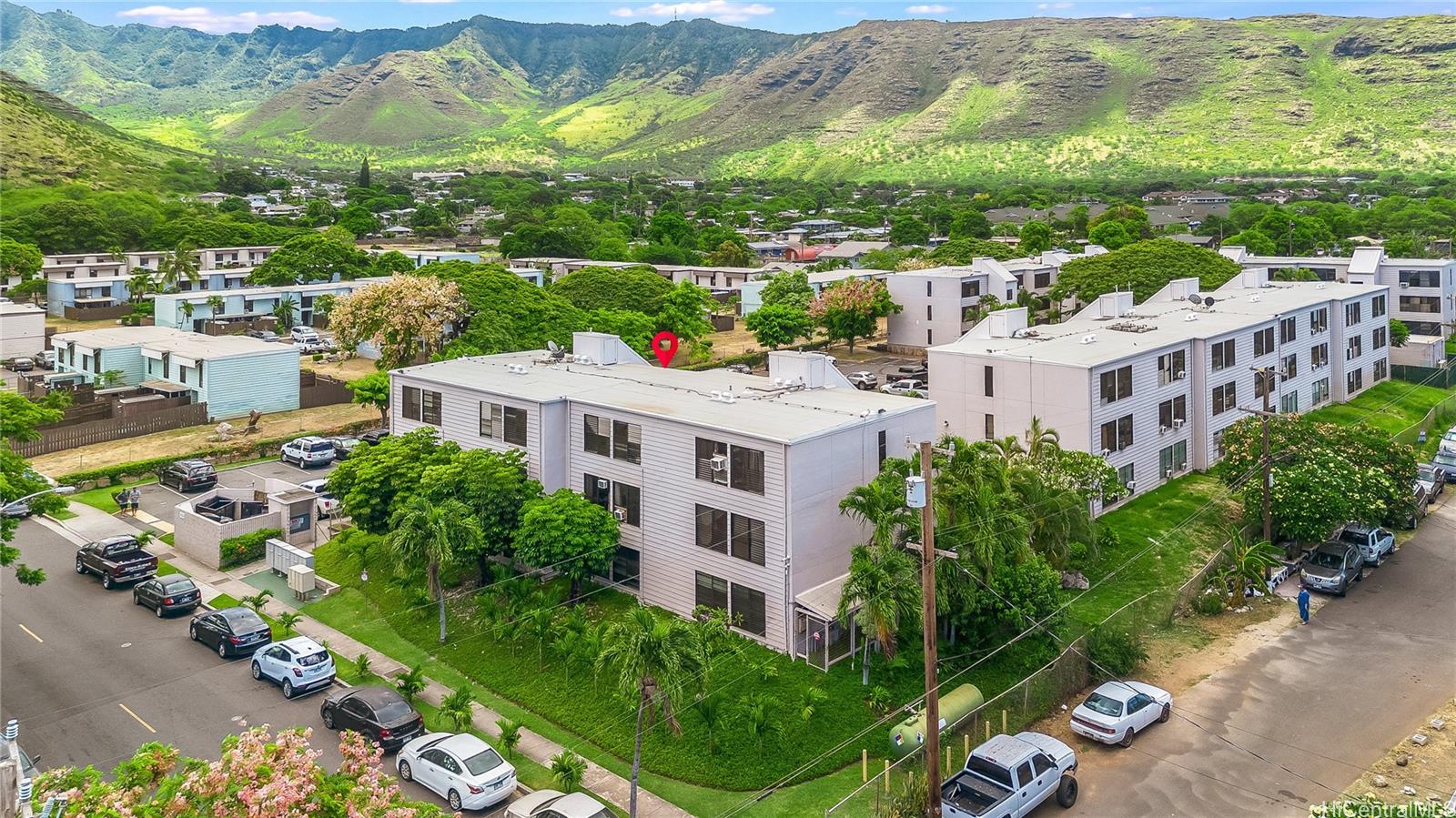 87-119 Helelua Street, Unit F202 Waianae, HI 96792 - Photo 22 of 25 an aerial view of residential houses with outdoor space and street view