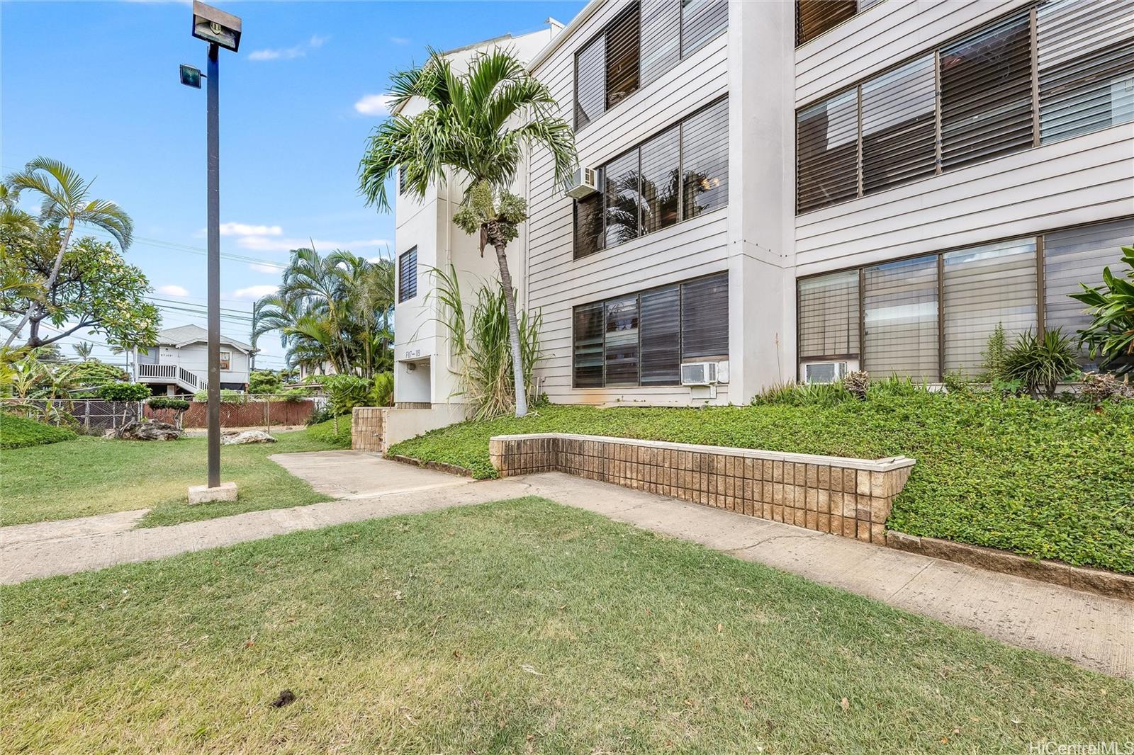 87-119 Helelua Street, Unit F202 Waianae, HI 96792 - Photo 23 of 25 a front view of a house with a yard