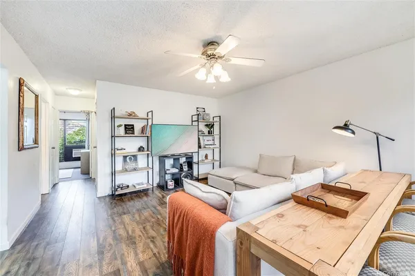a living room with furniture and wooden floor