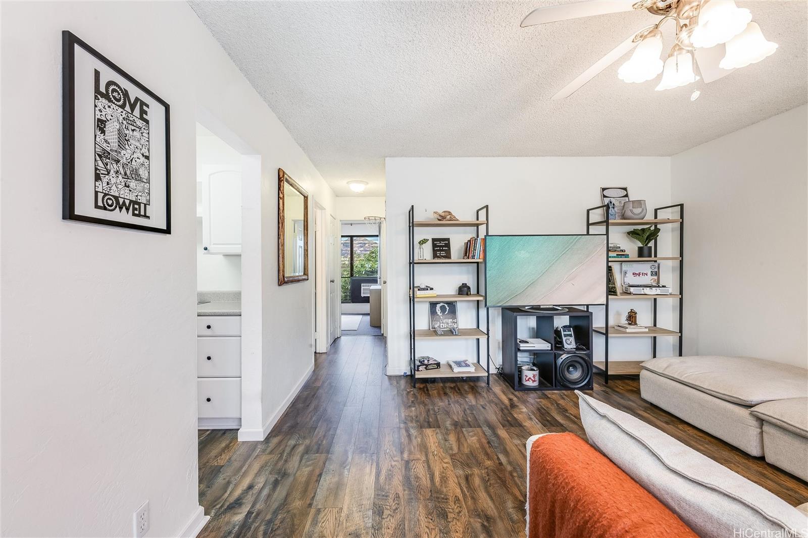 87-119 Helelua Street, Unit F202 Waianae, HI 96792 - Photo 5 of 25 a living room with furniture and a fireplace