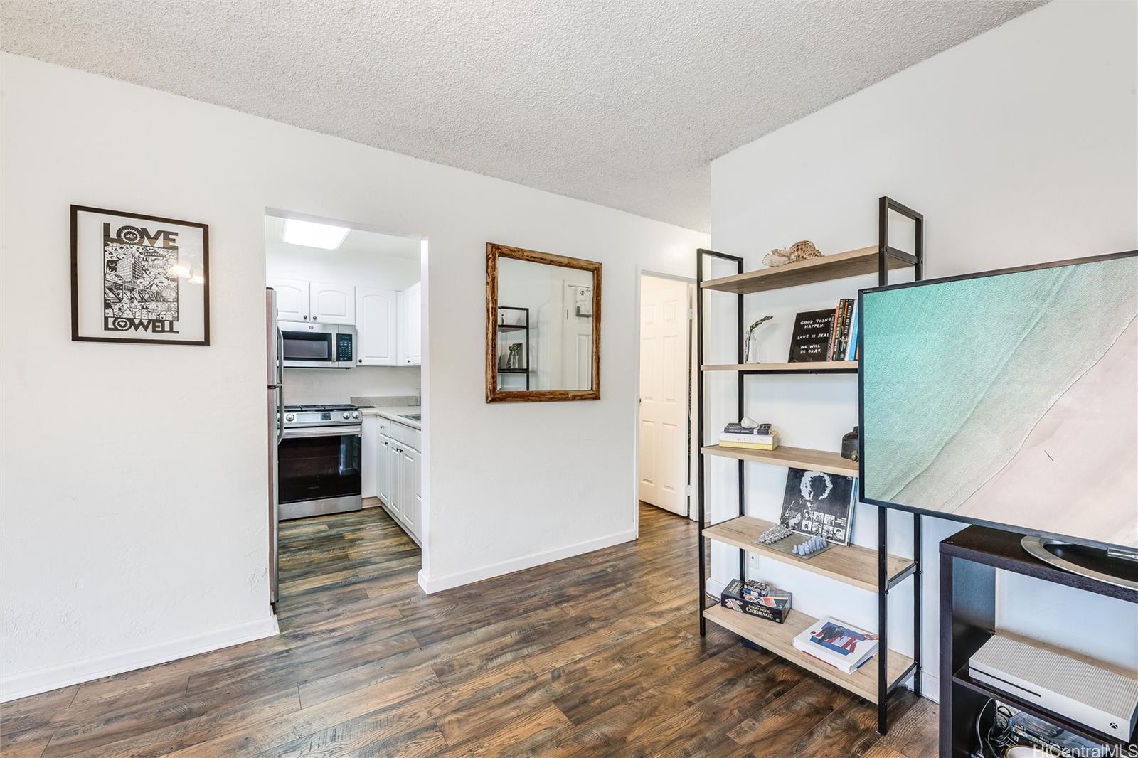 87-119 Helelua Street, Unit F202 Waianae, HI 96792 - Photo 6 of 25 a kitchen with a refrigerator and a stove top oven