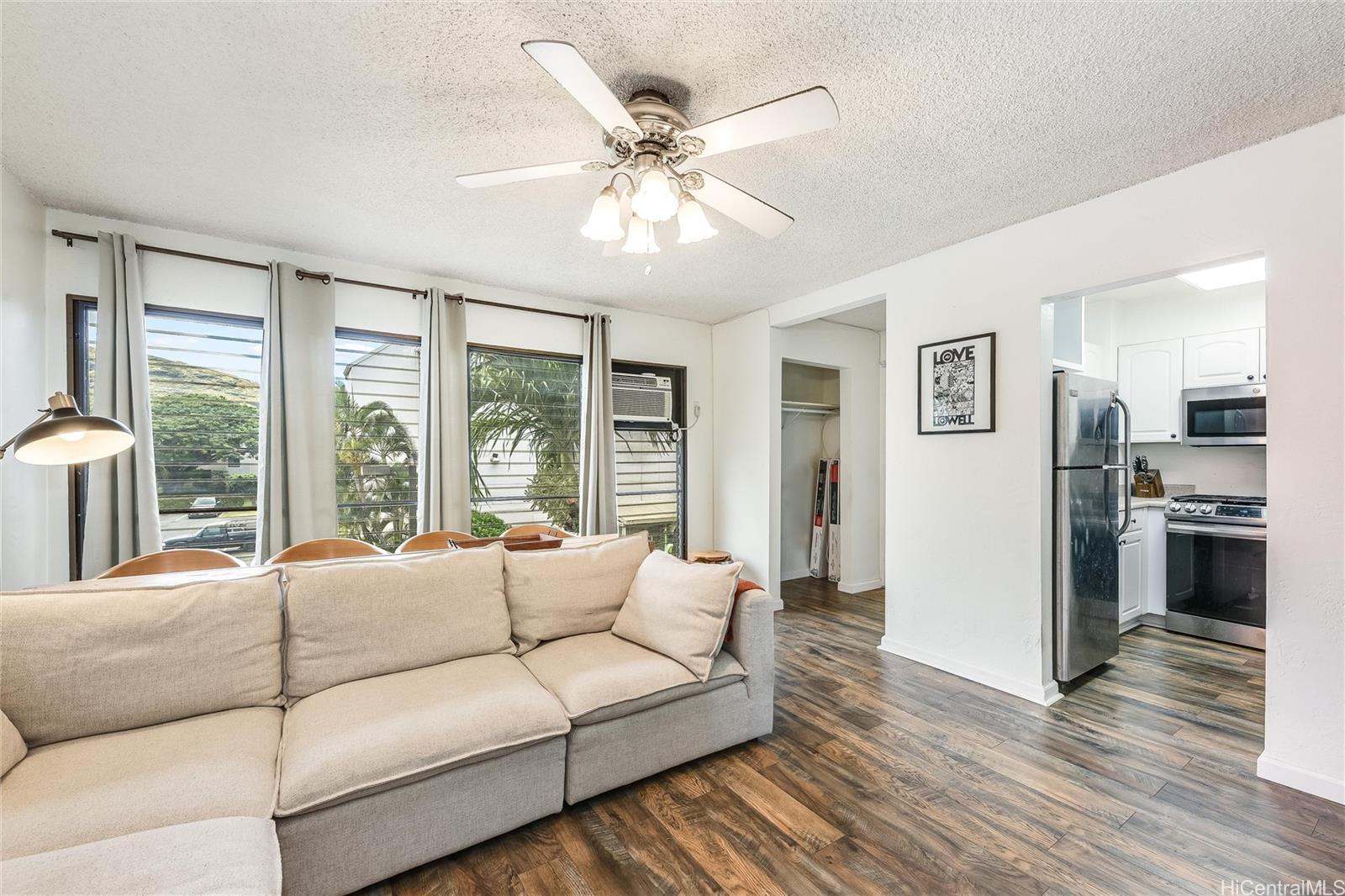87-119 Helelua Street, Unit F202 Waianae, HI 96792 - Photo 9 of 25 a living room with furniture and large windows