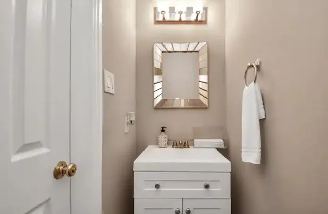 a bathroom with a sink toilet and mirror
