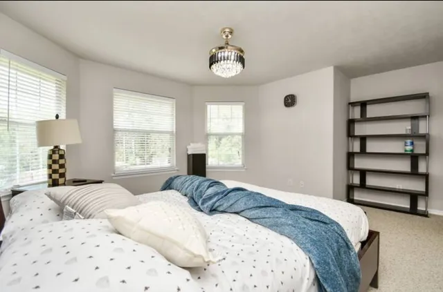 a bedroom with a bed and a window