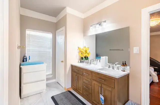 a bathroom with a sink double vanity and a mirror