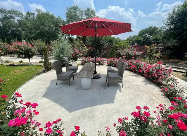 a view of a patio with couches and table under an umbrella