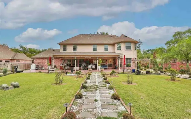 a front view of a house with swimming pool having outdoor seating