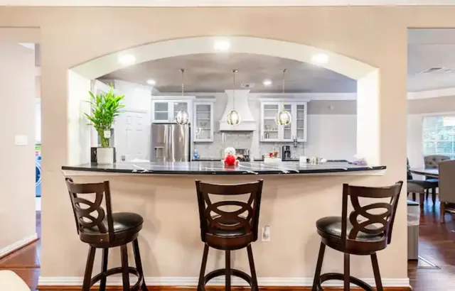 a kitchen with a table chairs stove and cabinets