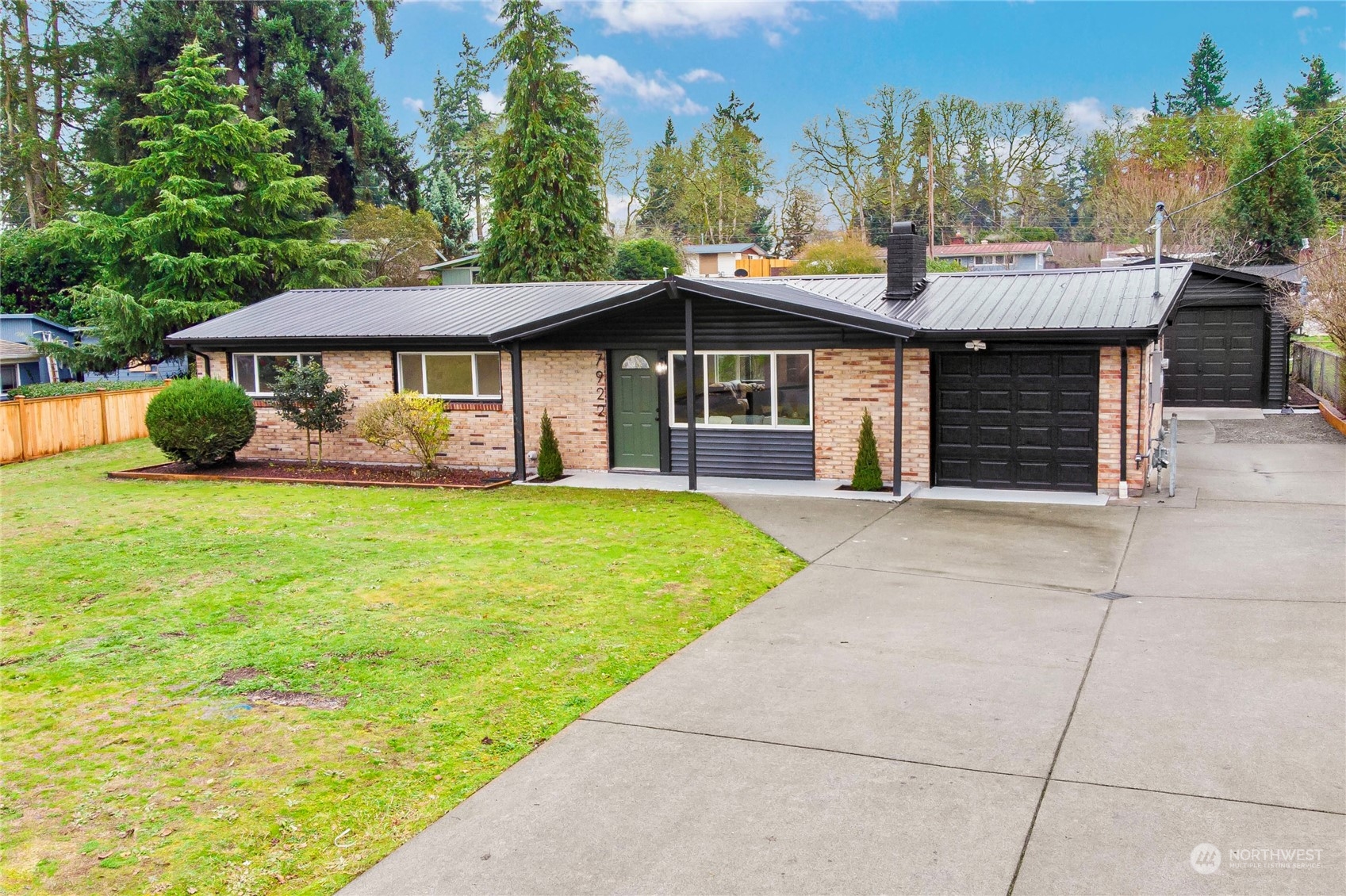 7922 Leschi Road Southwest Tacoma, WA 98498 - Photo 1 of 37 a front view of a house with a garden and trees