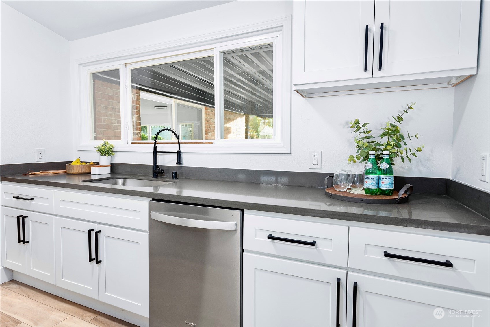 7922 Leschi Road Southwest Tacoma, WA 98498 - Photo 12 of 37 a kitchen with stainless steel appliances white cabinets and a potted plant