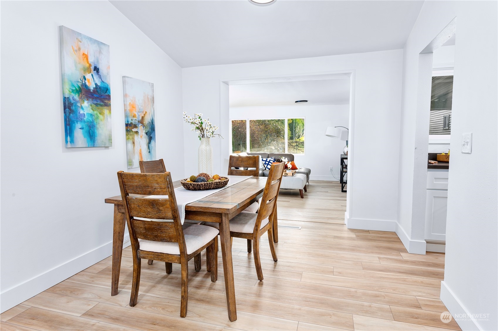 7922 Leschi Road Southwest Tacoma, WA 98498 - Photo 13 of 37 a dining room with furniture and wooden floor