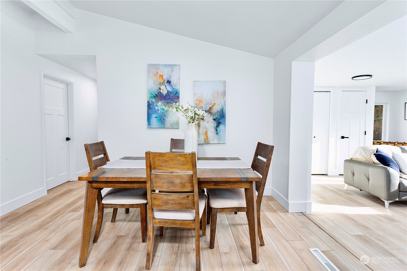 7922 Leschi Road Southwest Tacoma, WA 98498 - Photo 14 of 37 a dining room with furniture a rug and wooden floor