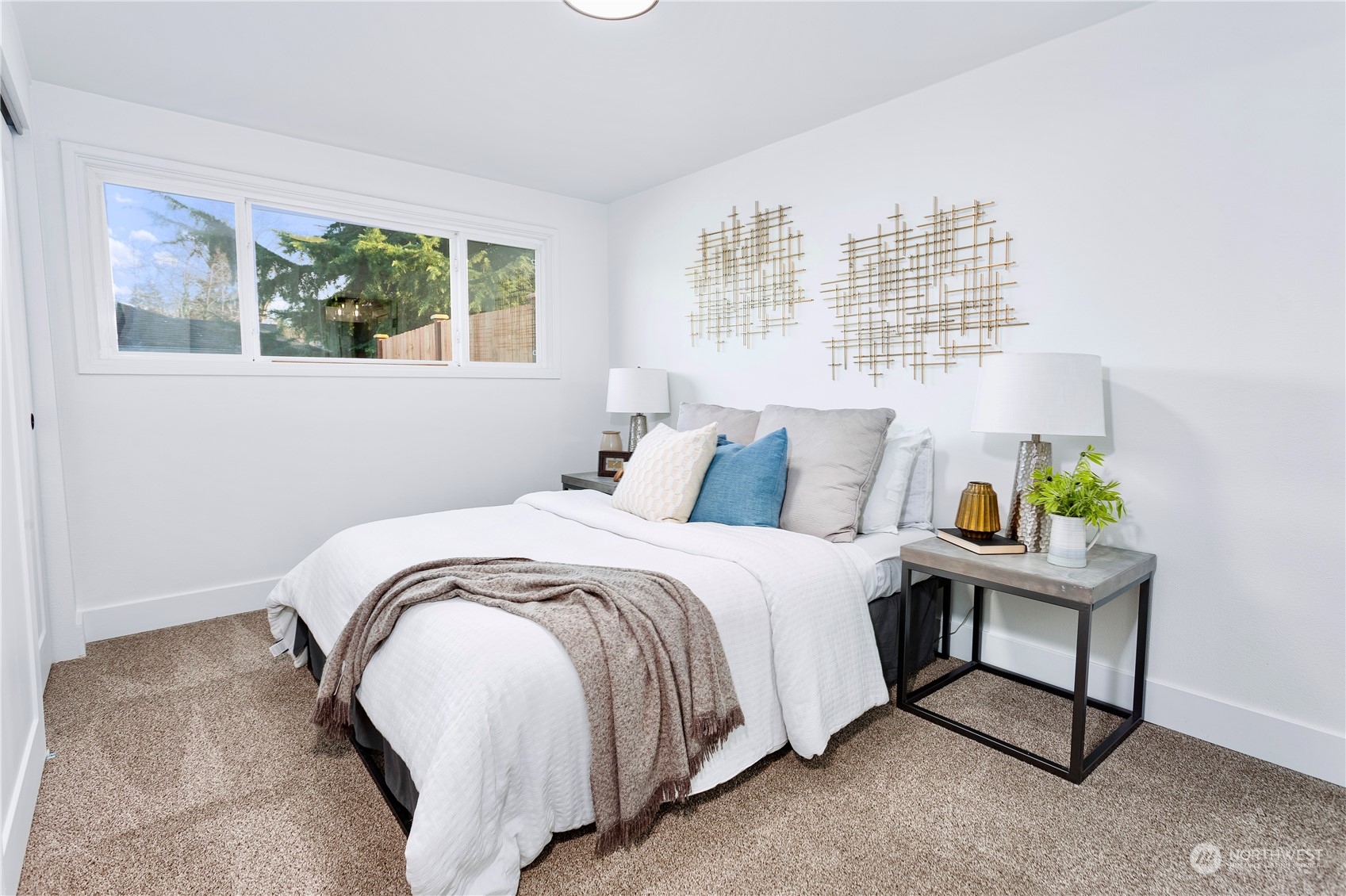 7922 Leschi Road Southwest Tacoma, WA 98498 - Photo 19 of 37 a bedroom with a bed a painting and a window