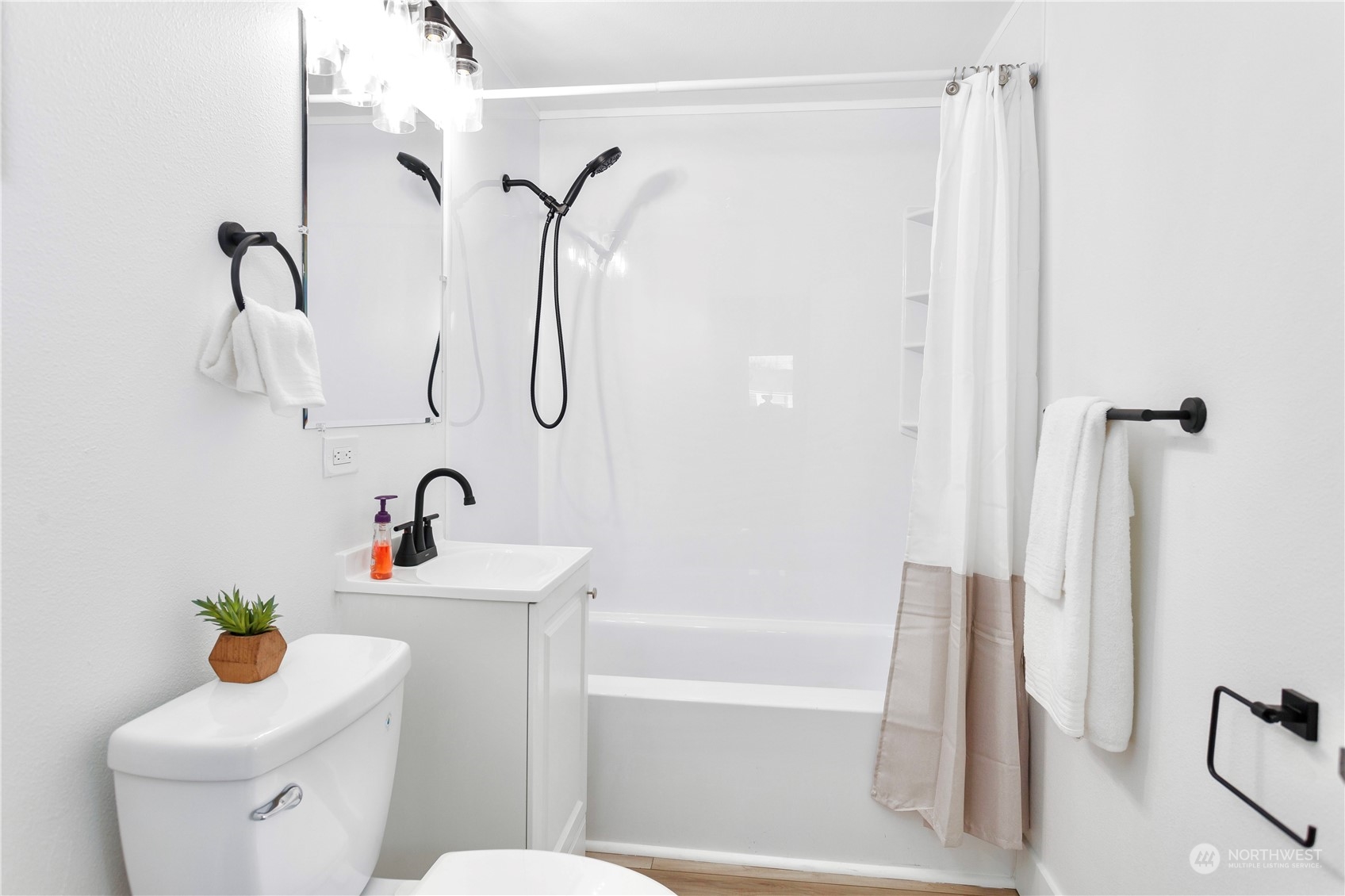 7922 Leschi Road Southwest Tacoma, WA 98498 - Photo 24 of 37 a bathroom with a sink a toilet and shower