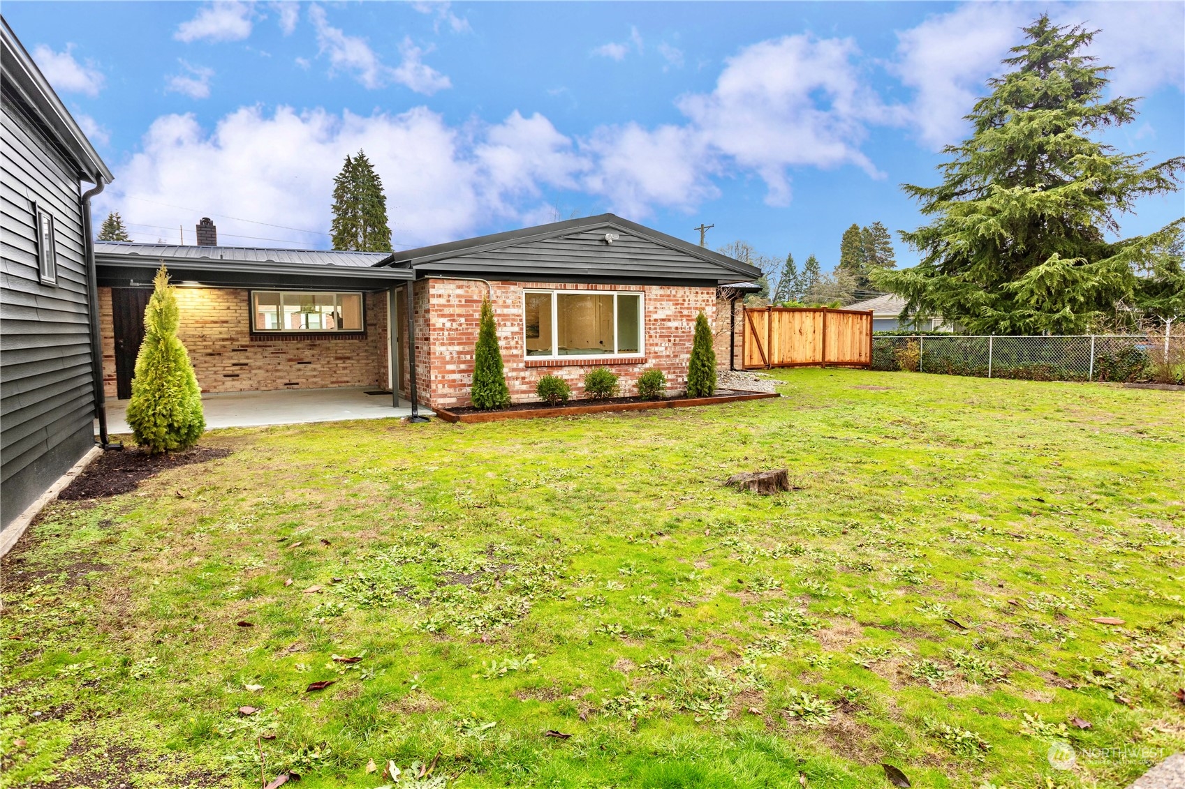 7922 Leschi Road Southwest Tacoma, WA 98498 - Photo 33 of 37 a view of a house with a yard and garage