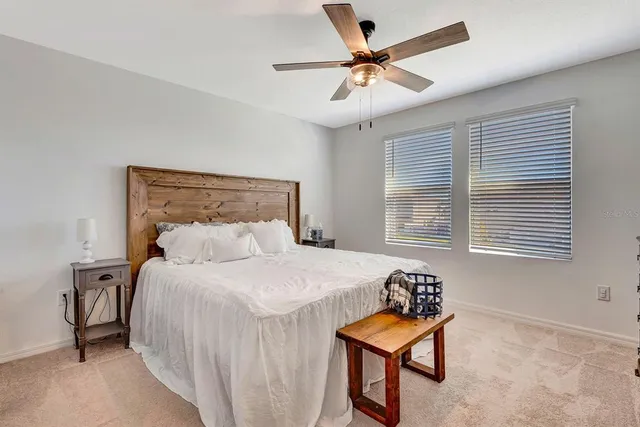a bedroom with a bed a chandelier and closet