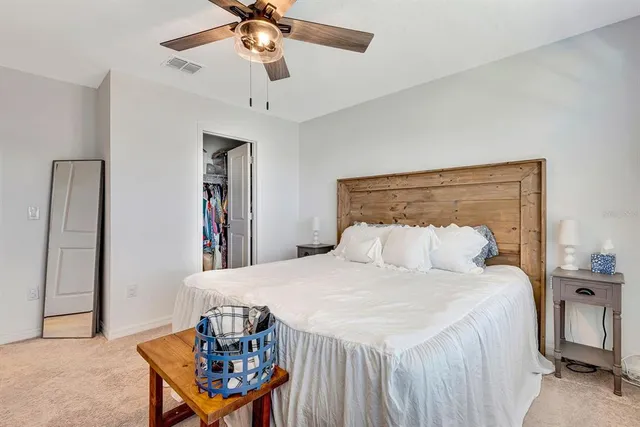 a bathroom with a toilet sink double vanity and mirror
