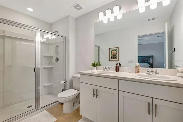 a bathroom with a sink toilet and shower