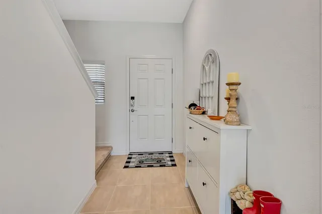 a kitchen with stainless steel appliances kitchen island granite countertop a sink a stove a dining table and chairs