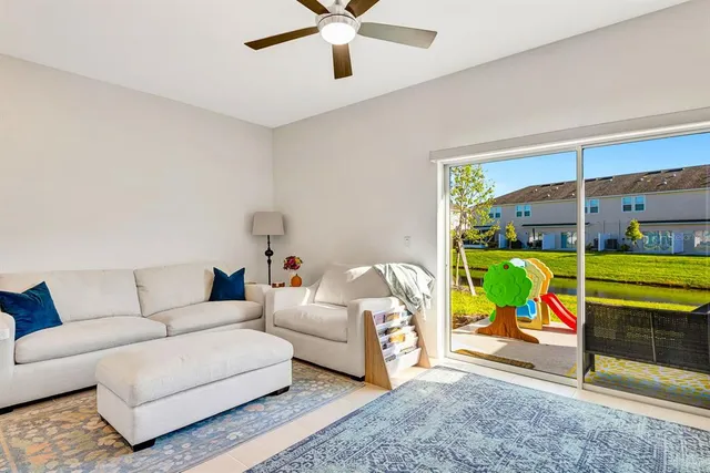 a living room with furniture and kitchen view