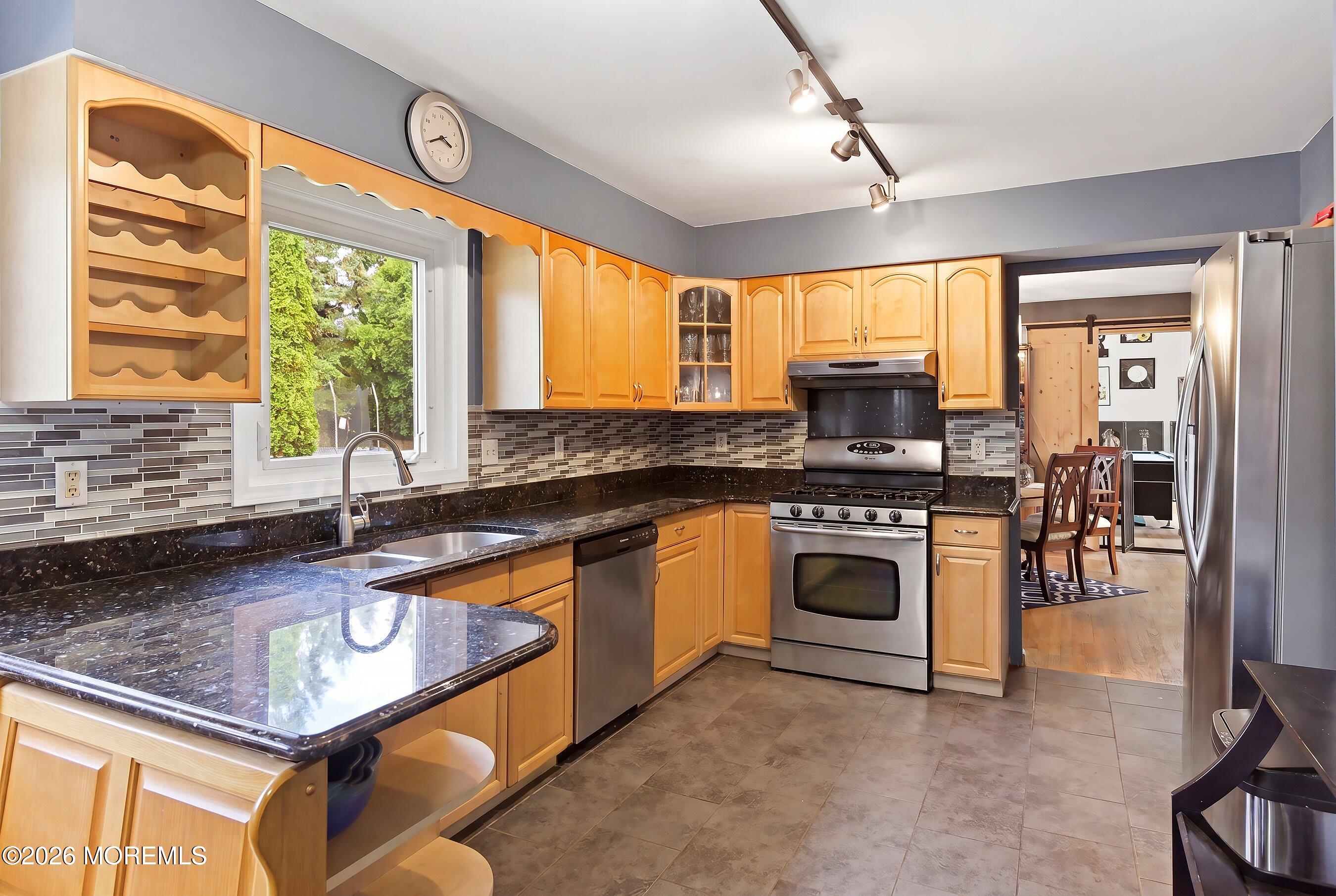 822 York Road Brick, NJ 08724 - Photo 10 of 37 a kitchen with stainless steel appliances granite countertop a stove a sink and a microwave