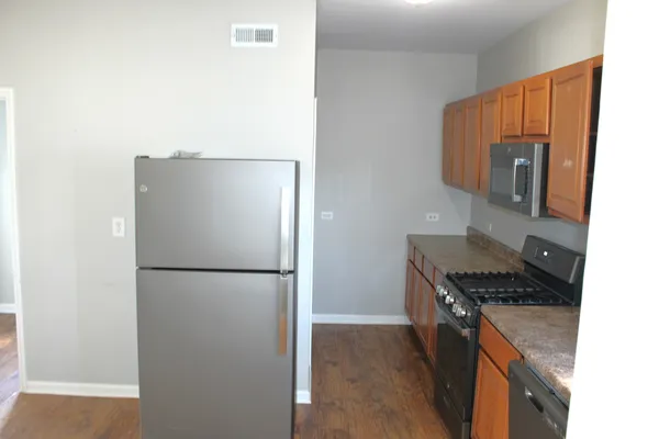 a kitchen with a refrigerator and a stove