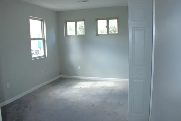an empty room that has a window in it