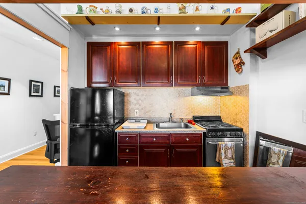 a kitchen with stainless steel appliances granite countertop a refrigerator stove and sink