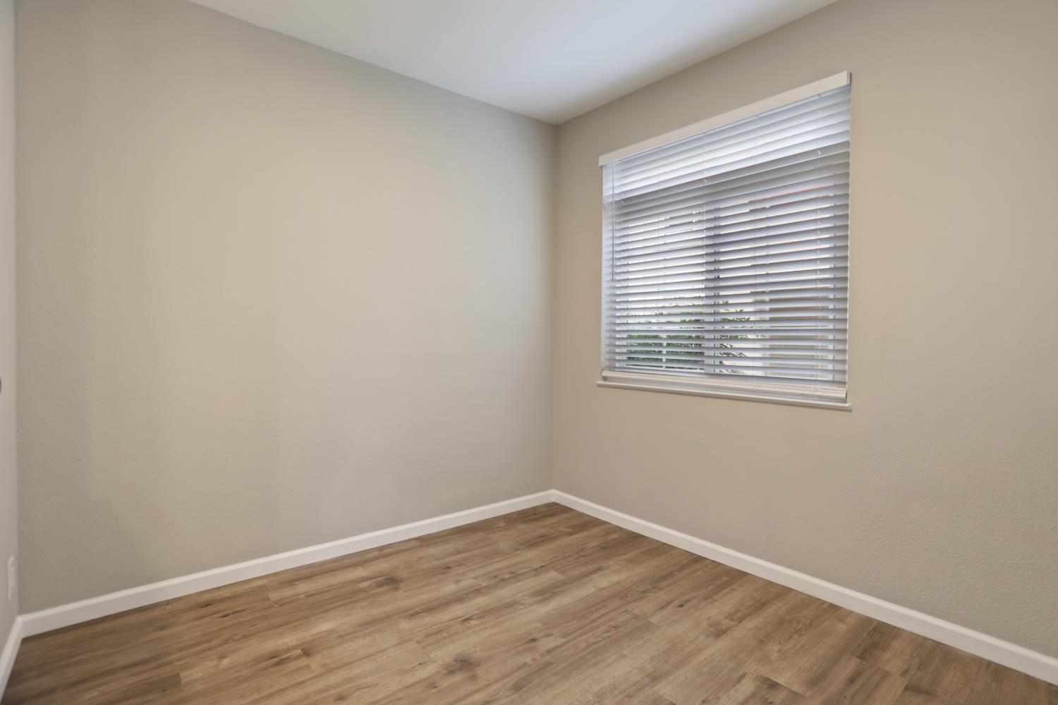 6986 Stagecoach Road, Unit B Dublin, CA 94568 - Photo 13 of 28 wooden floor in an empty room with a window