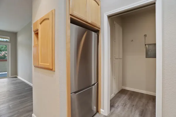 a view of a hallway with wooden floor and staircase