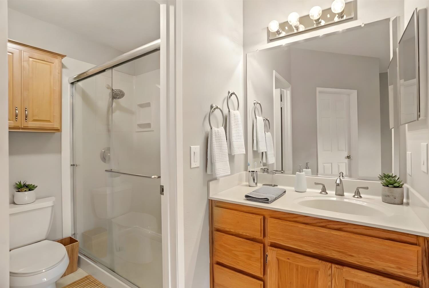 6986 Stagecoach Road, Unit B Dublin, CA 94568 - Photo 24 of 28 a bathroom with a sink a mirror a toilet and shower