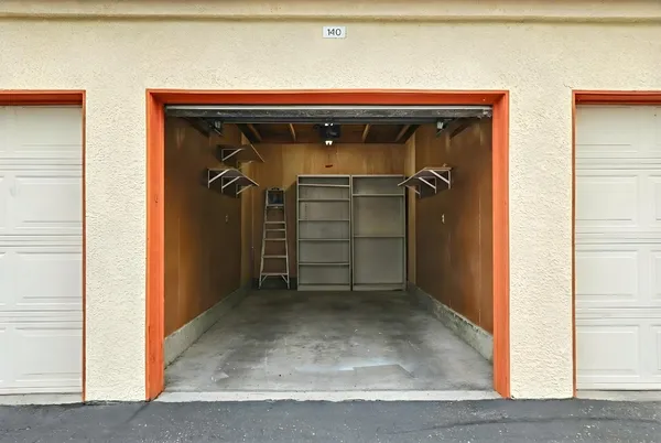 an empty room with floor to ceiling window and wooden floor