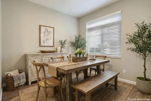 a view of a dining room with furniture and window