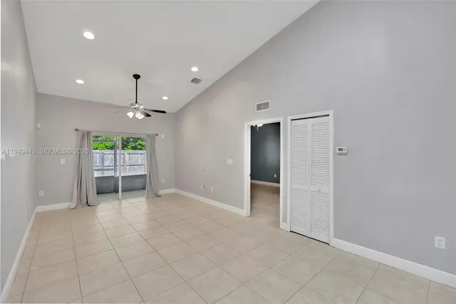 a view of a kitchen with a sink and a chandelier fan