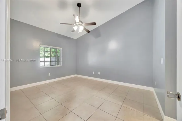 an empty room with fan and fan