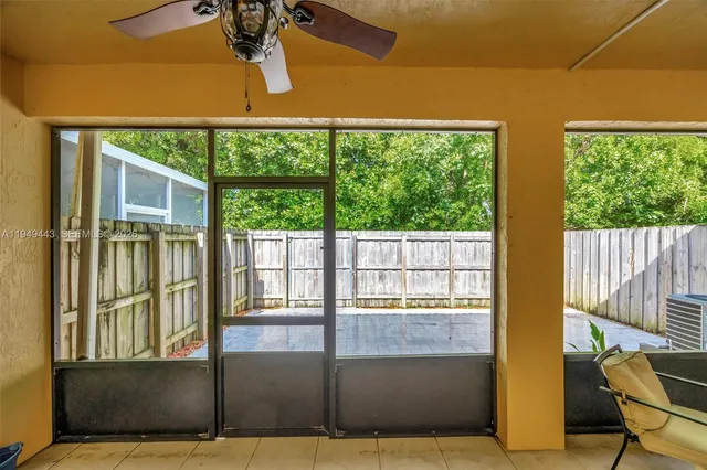 a view of a porch with chairs and couches with wooden floor