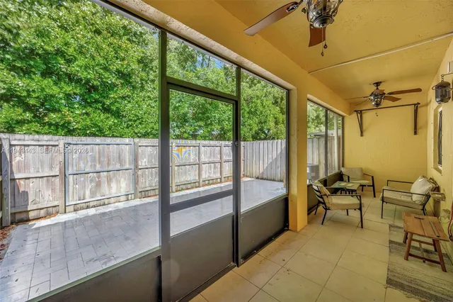 a view of backyard with wooden fence and trees