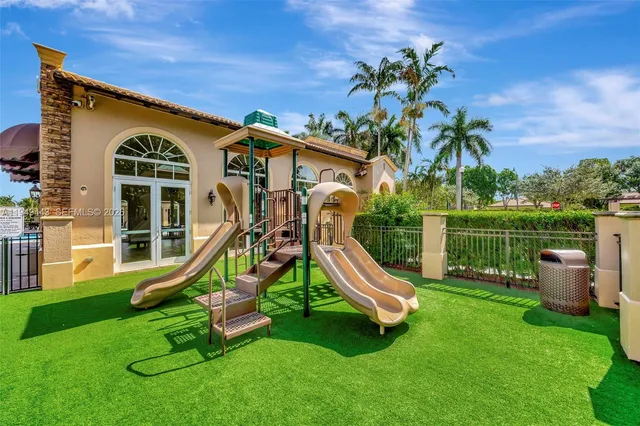 an aerial view of a house with swimming pool garden and lake view