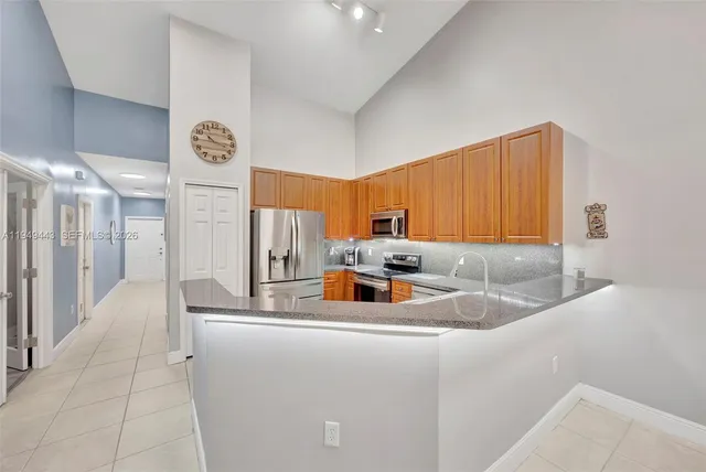 a kitchen with stainless steel appliances granite countertop a sink and a cabinets