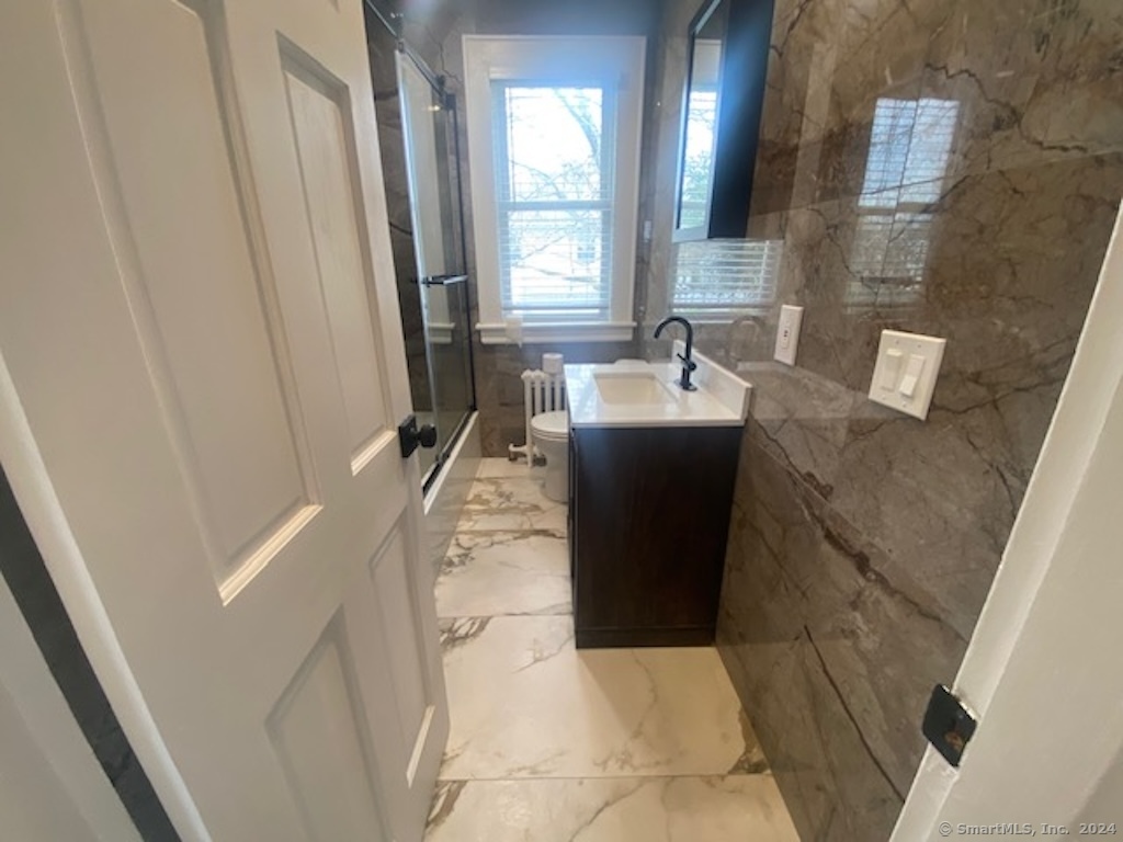 279 Wakelee Avenue Ansonia, CT 06401 - Photo 14 of 23 a bathroom with a tub sink and mirror