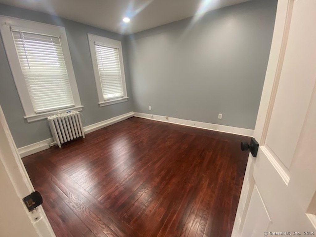 279 Wakelee Avenue Ansonia, CT 06401 - Photo 17 of 23 an empty room with wooden floor and windows